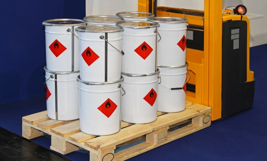 Industrial bucket cans with flammable material at forklift pallet